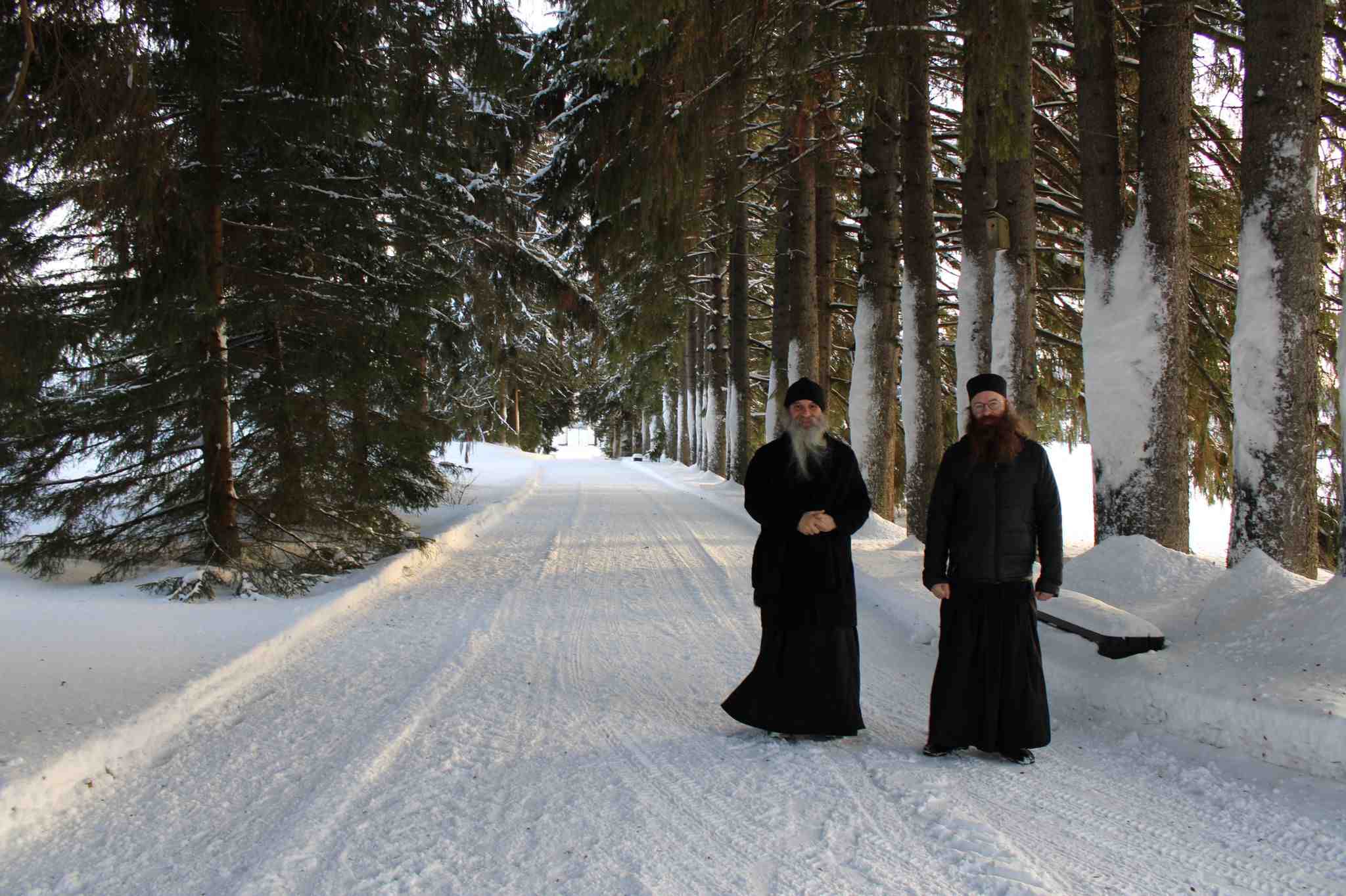 Mustiin viittoihin pukeutuneen ortodoksipappismunkit, ikonimaalari isä Luukas ja isä Damaskinos Ksenofontoslainen kävelevät pitkin Valamon luostarin lumista kuusikujaa