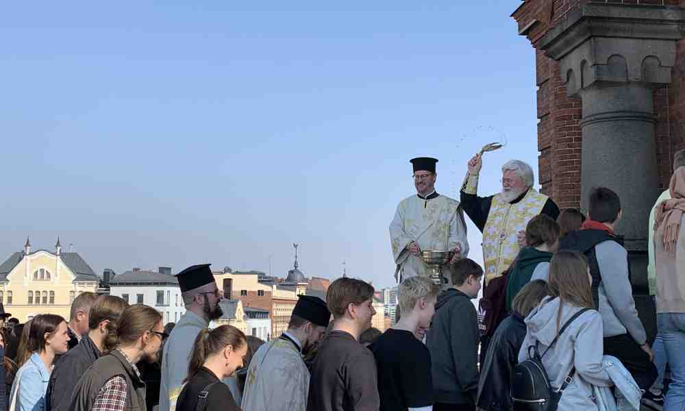 Arkkipiispa Leo vihmoo koululaisia pyhitetyllä vedellä Uspenskin katedraalin portailla
