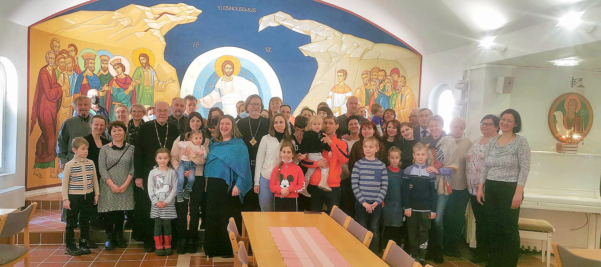 Ukrainan pakolaisia ja seurakunnan työntekijöitä Kuopion ortodoksisen seurakunnan seurakuntasalissa ryhmäkuvassa