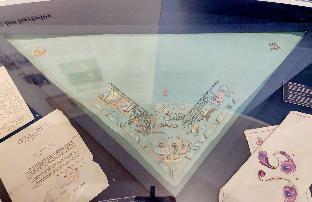 &Auml;iti Marian muiden keskitysleirivankien avustuksella kirjoma huivi, johon on kuvattu Normandian maihinnousu.